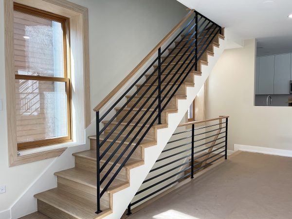 Interior custom railings with flat bars and wooden handrail