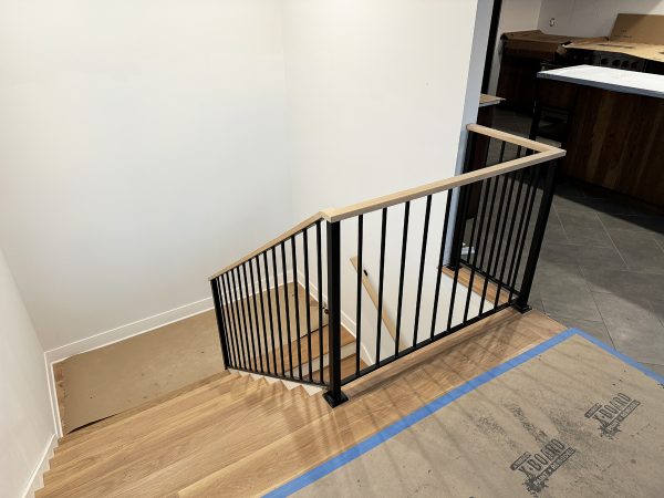 Modern railing with vertical pickets and white oak cap