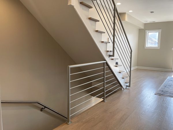 Interior horizontal pipe railing with round bars | Custom Railings