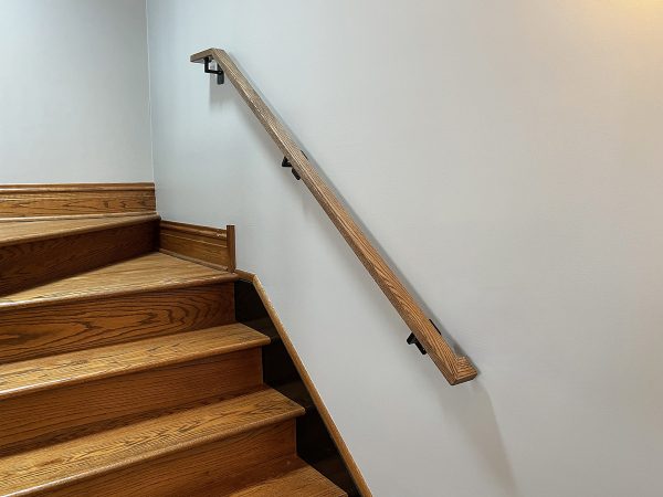 Interior wall handrail with stained oak top