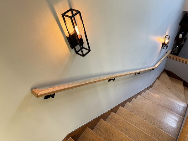 Interior wall handrail with wood cap and custom flanges