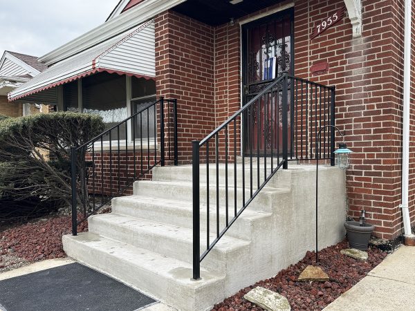 Exterior porch railings with vertical pickets and post caps