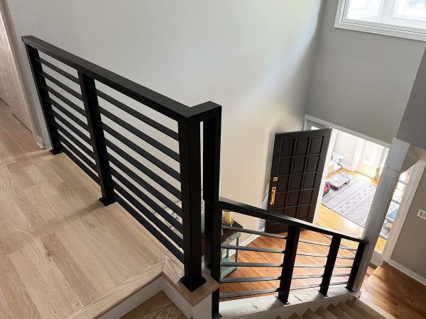 Interior railing with flat horizontal plates and heavy frame