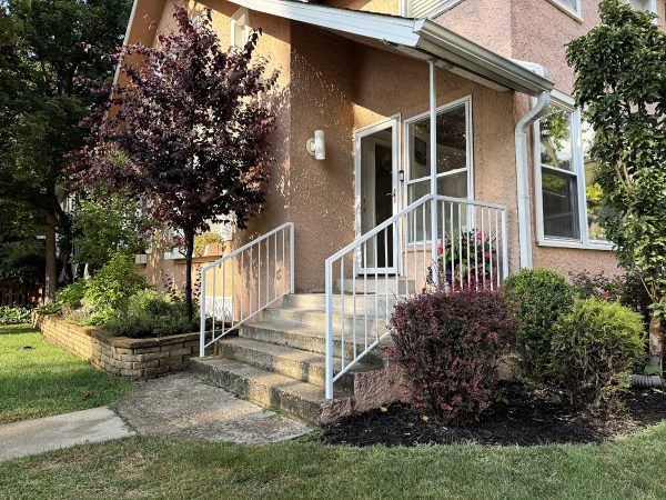 White railings with vertical pickets and roof support post