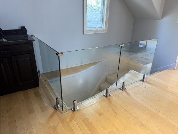 Frameless glass railing with floor brackets