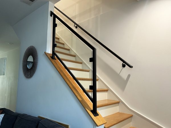 Stair railing with metal-framed glass