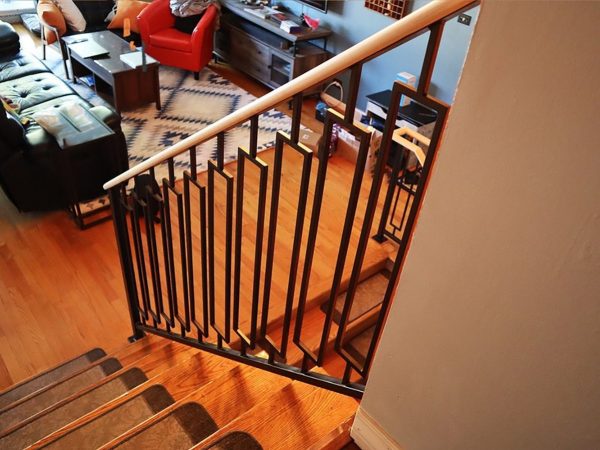 Decorative railing with custom rectangles and wood top. Oil-rubbed bronze